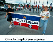 Participants in the annual Acadian Festival parade carry a banner for the Club Français, a non-profit regional organization dedicated to the preservation of Franch language in the St. John Valley.