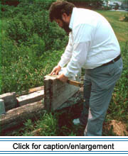 American Folklife Center fieldworker Ray Brassieur inspects pieces of the exterior walls left from a remodeling of the Val Violette House in Van Buren during the summer of 1991.