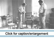 American Folklife Center fieldworkers Howard W. Marshall (left) and C. Ray Brassieur examine chairs in the collection of the Madawaska Historical Society.
