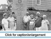 During their annual family reunion at Lavertu Settlement, Maine, members of the Lavertu family pose in front of a memorial to the family that has just been unveiled, July 1991.