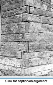 This corner angle close-up shows the “stacked and pegged” corner treatment applied to the hewn log exterior walls.