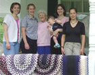 Local apprentices gather with 89-year-old master rug-braider Bertha Voisine of Fort Kent to display their rugs and celebrate completion of an apprenticeship project, 2003. Acadian Archives/Archives acadiennes photograph by  Lisa Ornstein.