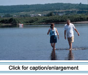 The St. John River has had a profound influence on the culture of the St. John Valley, one which has changed over time but remains important today. Here, Nicole Bellefleur and teacher Paul Baker wade in the St. John River to cool off on a hot day.
